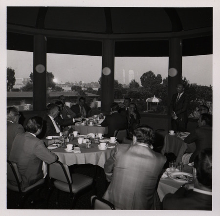 Photograph of people sitting around tables during the "Honoring Glenn V. Gibson" event