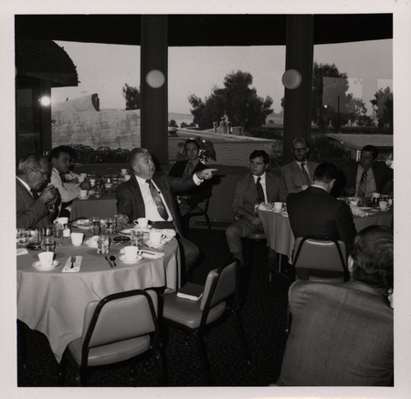 Photograph of people sitting around tables during the "Honoring Glenn V. Gibson" event