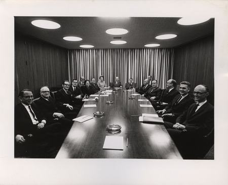 Photograph of Dwight Ink with a group of people sitting around a table