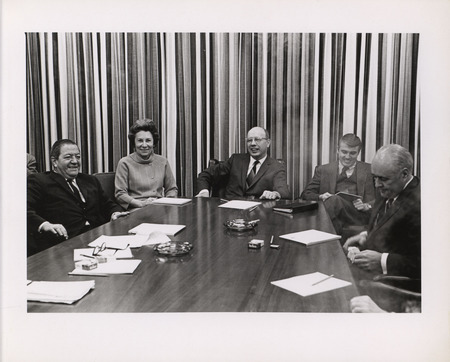 Photograph of Dwight Ink with a group of people sitting around a table