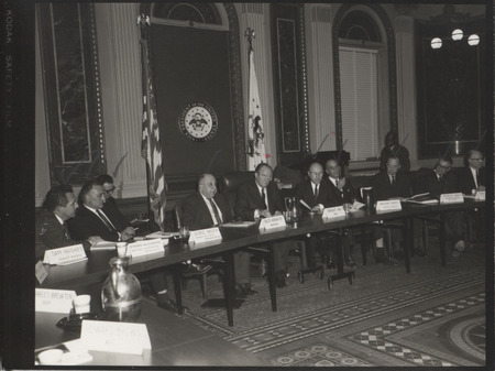 Photograph of Dwight Ink with others sitting around tables at the Indian Treaty Room