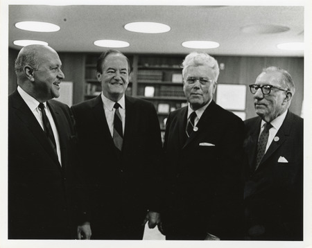 Photograph of Robert Weaver, Hubert Humphrey, and other men