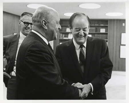 Photograph of Robert Weaver shaking hands with Hubert Humphrey