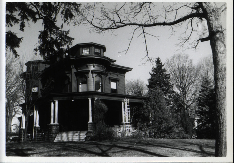 The house of Frederic Leopold located in Burlington, Iowa, situated overlooking the bluffs of the Mississippi River, 1966. A wooden wood duck house is attached to a tree located nearby the house.