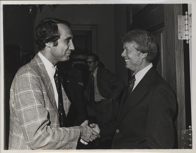 Photograph of Edward Mezvinsky and President Jimmy Carter shaking hands.