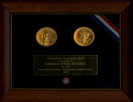 National Bicentennial Medal presented to Edward Mezvinsky by the American Revolution Bicentennial Administration in 1976. The medal is incorporated into a plaque that includes a description of the medal's symbolism on the plaque's back.