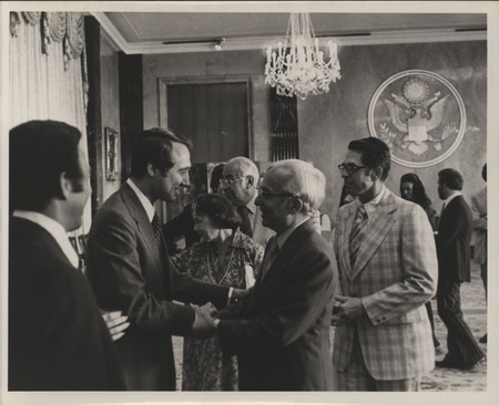 Photograph of Edward M. Mezvinsky meeting people after his speech during his swearing in ceremony as the U.S. Representative to the United Nations Human Rights Commission.