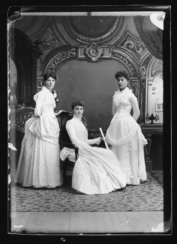 Graduation from Cornell College, Mt. Vernon, Iowa, 1888. The three women dressed in white dresses are the sisters of Descartes Pascal. From left to right:Lucy, Arcana Celestia (Lettie), and Laura.