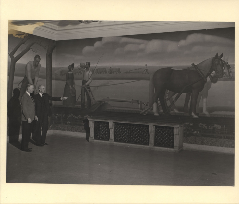 Christian Petersen and Charles Harvey Brown, director of Iowa State College Library, standing in front of the Grant Wood mural "Breaking the Prairie."