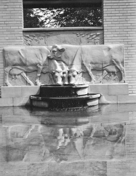 Front view of the "History of Dairying" bas-relief and sculpture fountain (terra-cotta, 1934), located at the Dairy Industry Building (later the Food Sciences Building) on the Iowa State University campus. Cco: Silver gelatin photograph on board