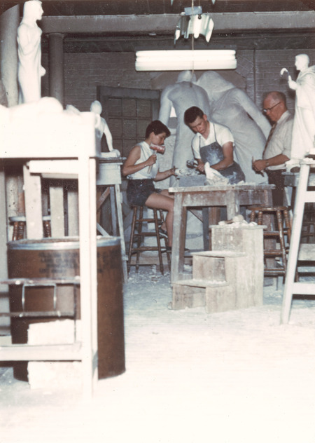 Christian Petersen in his studio with two students. The studio was located in the Veterinary Quadrangle (later named Lagomarcino Hall). Figures from "Conversations"are in the background, and a small-scale model of Saint Bernard of Clairvaux to the right. Cco: Silver gelatin photograph on board