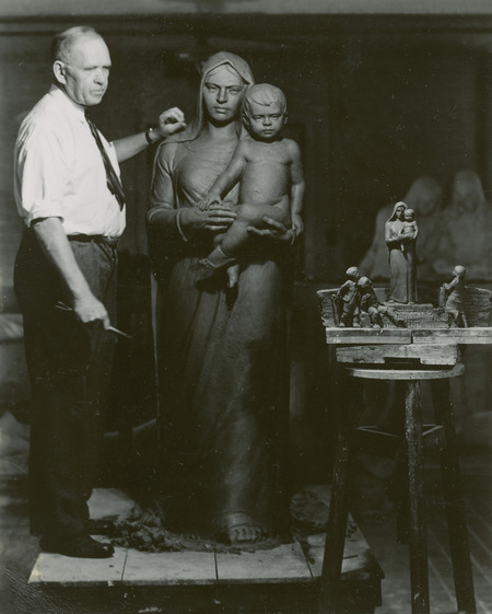 Christian Petersen in his studio working on a full-size clay model of the Madonna of the Schools, with small clay versions of all the Saint Cecilia sculptures. Cco: Silver gelatin photograph on board