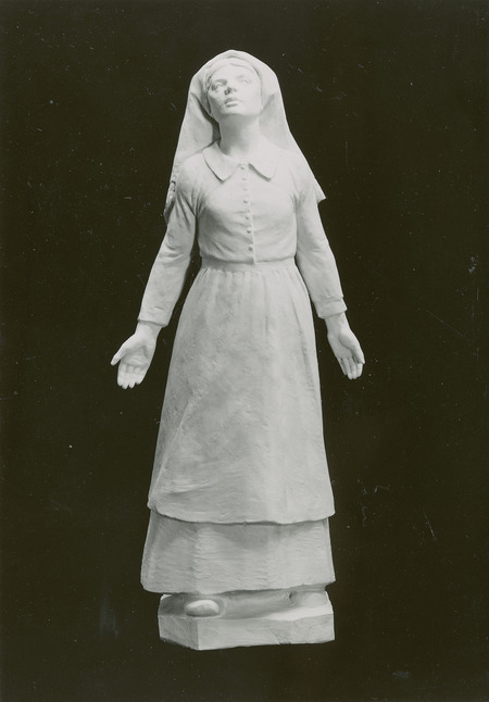 Painted plaster figure of St. Bernadette of Lourdes. Given to St. Cecilia's Church, Ames, Iowa, for the sanctuary by Petersen. Measuring 59.7 cm x 26.7 cm x 18.4 cm. Cco: Silver gelatin photograph on board