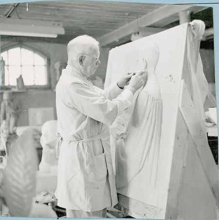 Christian Petersen in his studio working on the terra-cotta bas-relief of pastor Samuel Nichols for the Collegiate Methodist Church in Ames, Iowa. Cco: Silver gelatin photograph on board