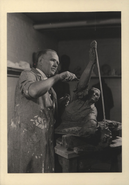 Photograph of Christian Petersen sculpting in clay on a proposed World War I memorial.