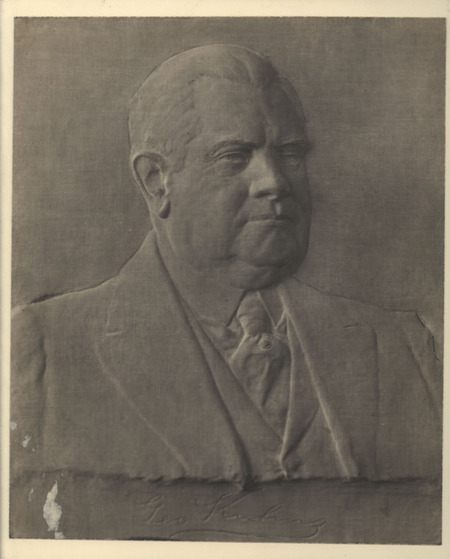 Photograph of a Bas relief of George Kuhns, looking to the right, by Christian Petersen.