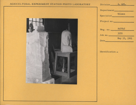 Photograph of Christian Petersen's studio in 1961. The following pieces are visible: "Head of Christ," a small model of "Conversations," and a robed Christ figure statue.