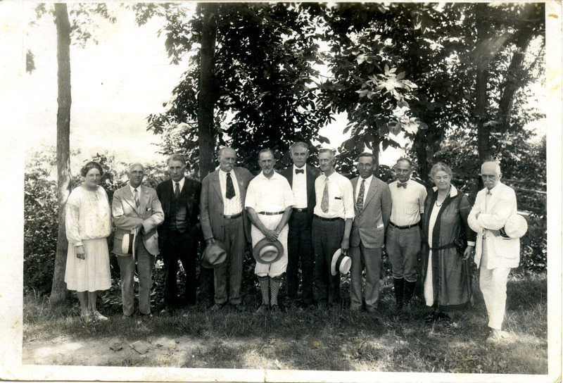 Eleven faculty members from the American School of Wildlife Protection in McGregor posing outside, August 7-18, 1928. Photograph originally titled "Faculty of Wildlife School at McGregor, Iowa." Rosene provides details on back of photograph.