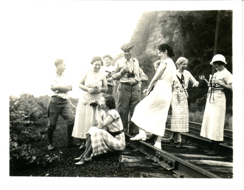 A group of several men and women, many with binoculars, on a bird hike near McGregor, August 1935. Photograph originally titled "Group on a bird hike." Rosene provides details on back of photograph.