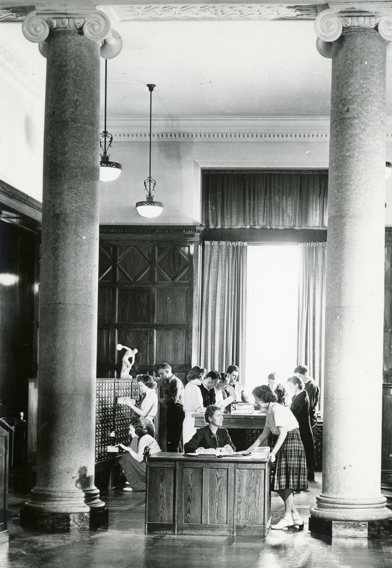 Student consulting a librarian at the Card Catalog Information Desk