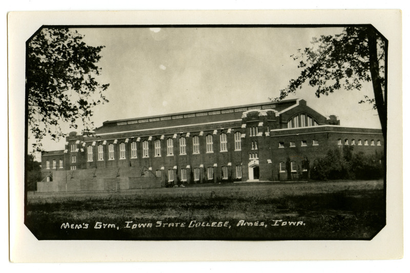 This southeast view of the back (south) of State Gymnasium shows the handball courts that have been constructed outside the building. The photo is labeled "Men's Gym, Iowa State College, Ames Iowa.".