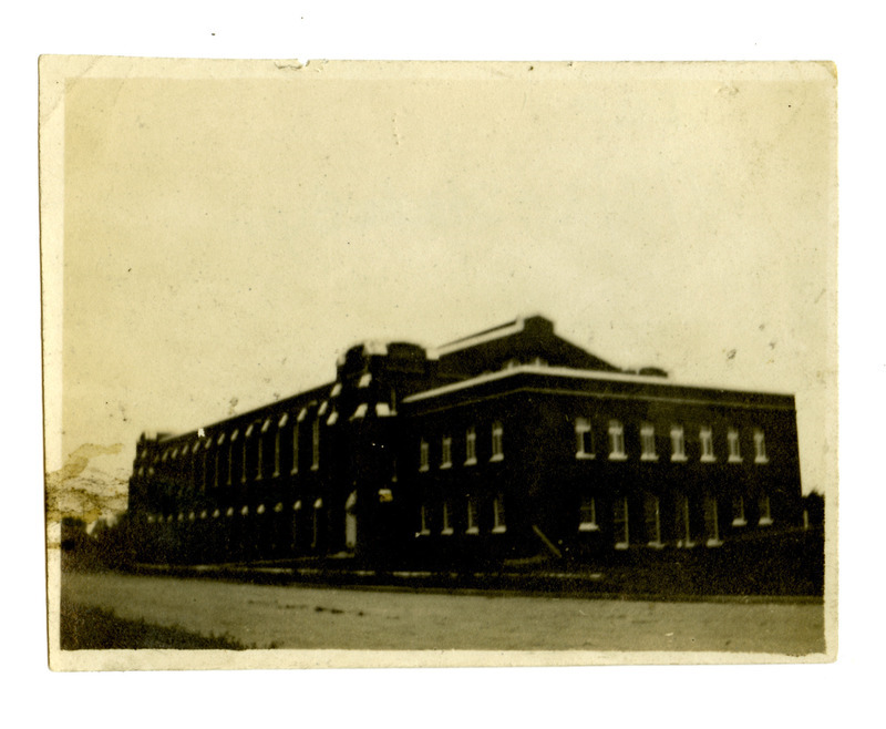 The State Gymnasium is shown soon after completion, viewed from the northwest, in this dark exposure. Plantings near the road are very small.