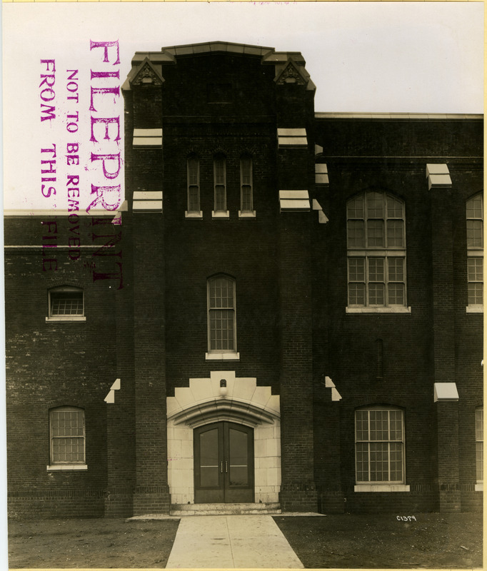 The front (north) entrance on the east end of the State Gymnasium is marked by a tower, one of four entrance towers.