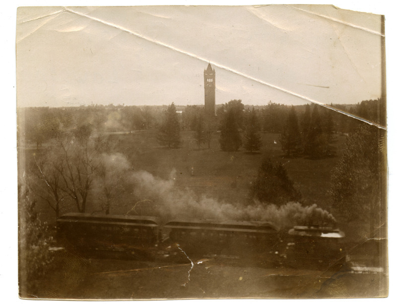 The Ames & College Railway (The Dinkey) steams through campus with the Campanile in the background.