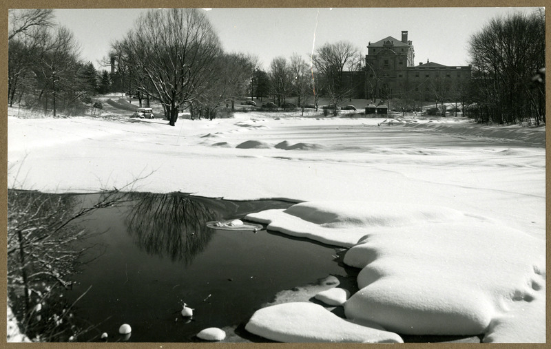 Frozen and snow covered Lake LaVerne. Small unfrozen section near the Lake's edge is in the foreground. Photograph appeared in the February 1950 issue of News of Iowa State.