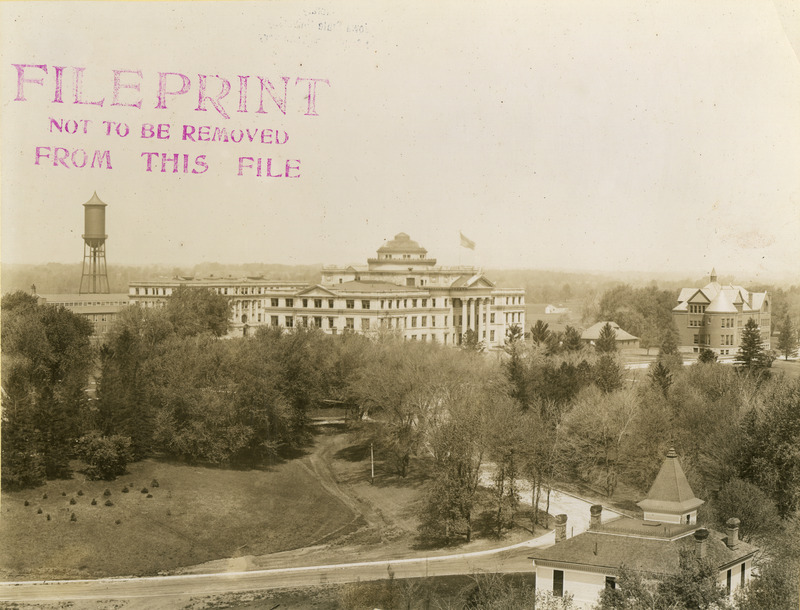 Viewed from above, the buildings from left to right are Engineering Hall II (later known as Marston Hall); Central Building (later known as Beardshear Hall); the Hub (Dinkey Station); and Morrill Hall. The Marston Water Tower is on the far left, May 5, 1913.