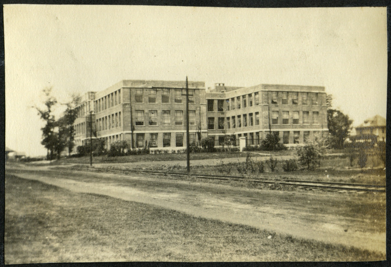 This view shows the Chemistry Building (later known as Gilman Hall) before it burned. The Dinky Railroad Tracks are parallel to the dirt road, 1910.