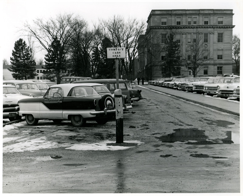 Cars of the 1950 or 1960 era are parked on the north side of Marston Hall, 1959 or 1960.