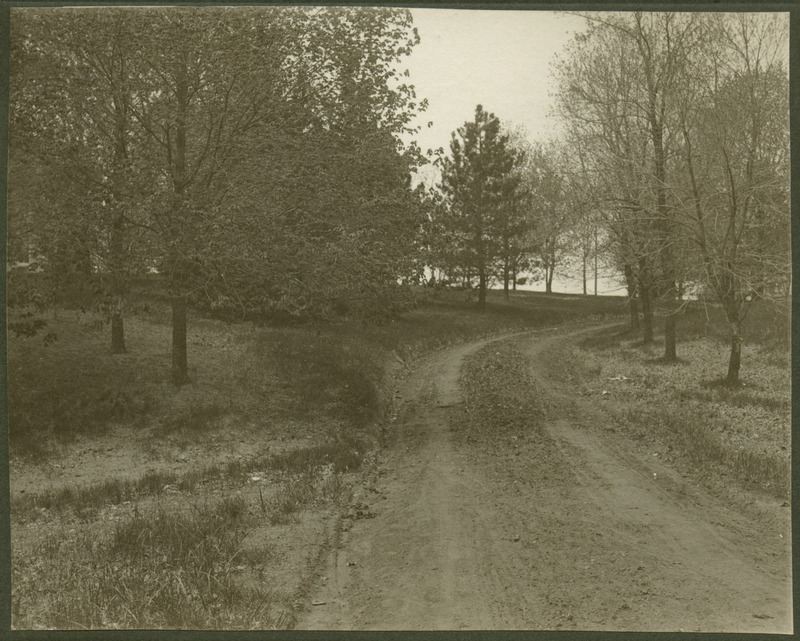 Dirt road leading towards Memorial Union at Iowa State University. Road later became a walkway.