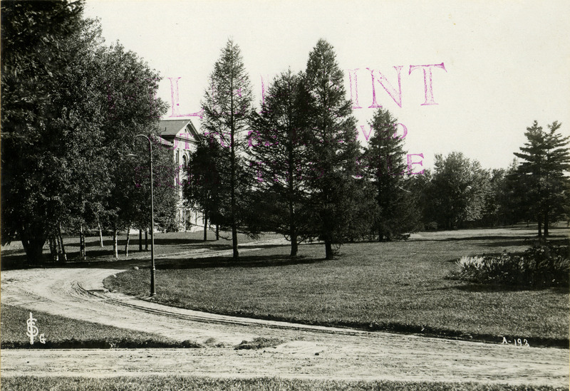 Iowa State University in 1905. Dirt road is seen in the foreground, unknown building is seen in the background toward the left.