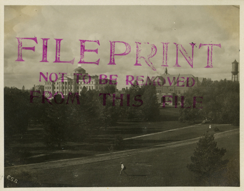 A man in walking through campus in the foreground. In the background are left to right: Central Building (later known as Beardshear Hall), Morrill Hall, and the Marston Water Tower, November 5, 1905.