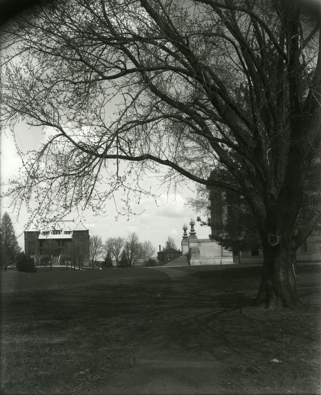 Curtiss Hall entrance from south walk. "Old Botany" (now Carrie Chapman Catt Hall) in background with greenhouse and horticulture building to left. April 20, 1913.