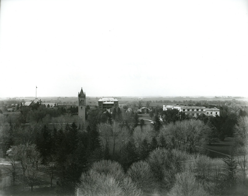 This view of campus from left to right shows Horticulture Barn, Ladies Hall (later known as Margaret Hall), the Campanile, Bevier House, Old Botany (later known as Carrie Chapman Catt Hall, Quadrangle (later known as Lagomarcino Hall), greenhouses, "Old Hort" (later known as Old Horticulture), and Agriculture Hall (later known as Curtiss Hall), May 5, 1913.