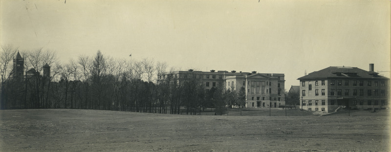 This panoramic view is looking northwest from the pasture behind Knapp's Woodruff Place. Viewed from left to right are Coover Residence, Agricultural Hall (later known as Curtiss Hall), and the Dairy Building. The Campanile, Central Building (later known as Beardshear Hall), and the Marston Water Tower are visible through the trees on the left. The sheep pasture was the location for the women's dormitories in 1954.