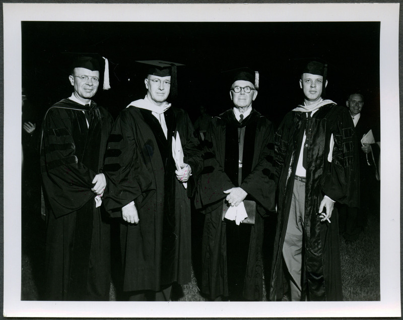 Standing in caps and gowns from left to right are Professor W. G. Murray, Ezra T. Benson, President Friley, and Floyd Andre, the Dean of the College of Agriculture. Ezra T. Benson, United States Secretary of Agriculture, received the honorary Doctor of Agriculture degree at the commencement ceremony, 1953.