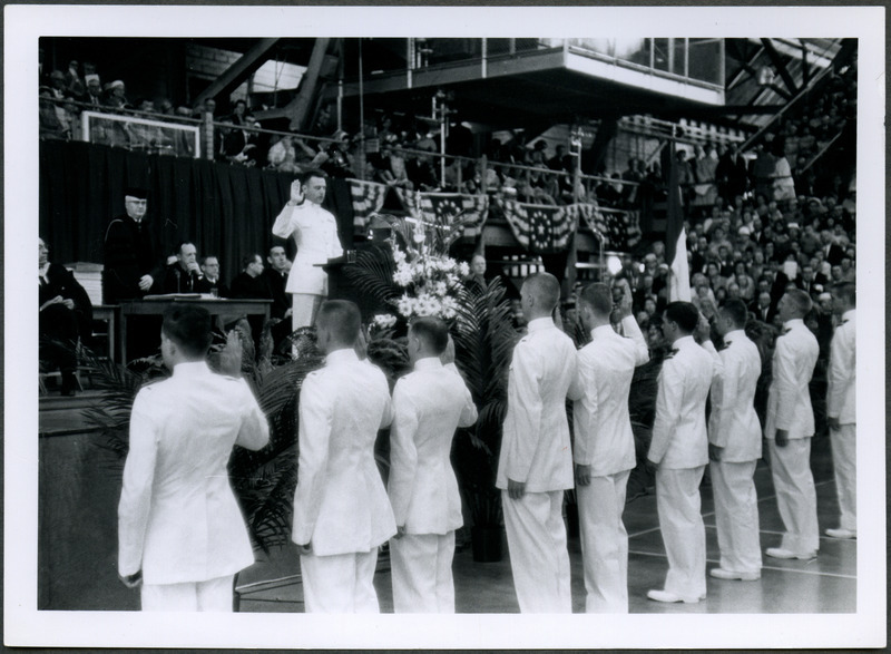 Naval officers are taking an oath at the commissioning of officers during commencement ceremonies at the Armory.