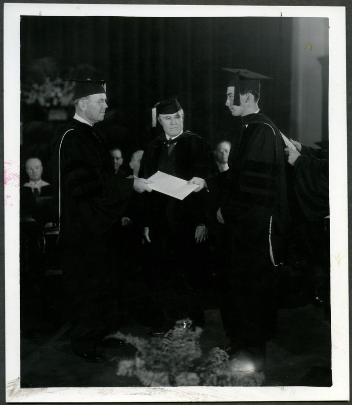 Student receives diploma from President Charles Edwin Friley at a commencement ceremony held in 1941. Orland Russel Sweeney, Head of the Department of Chemical Engineering, is also present.