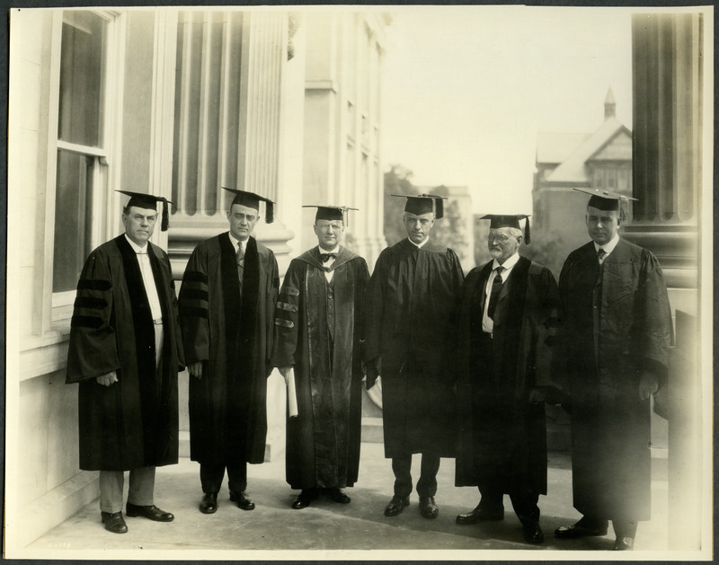 Standing in their graduation caps and gowns from left to right are Professor Alan Kimball, Professor Shull, President Raymond Pearson, Warburton (student), Professor Pedersen, and Christie (student), 1925.