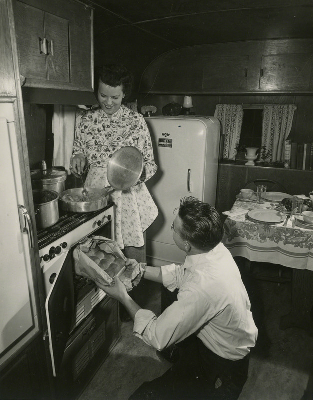 Janet and Dale Grimes cook Thanksgiving dinner at Pammel Court, the then residency for married students in 1948.