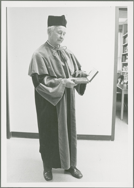 Earl O. Heady is wearing the academic robes and holding a medal in a box that were part of his honorary doctoral degree from Warsaw Agricultural University in Poland, 1979.