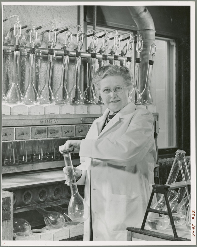 Dr. Pearl Swanson, Professor of Food and Nutrition, is shown in a laboratory with large test tubes, May 1947.