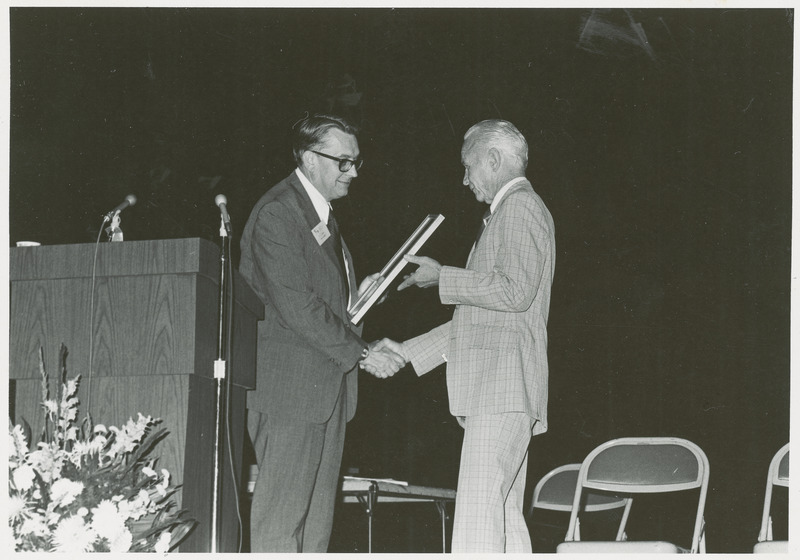 Earl O. Heady receives special recognition for winning the 1977 Browning Award, at the American Agricultural Economics Association meeting in Blacksburg, Va. in 1978, from AAEA president Dr. Jim Hildreth. Heady also won an AAEA award in 1976. The Edward W. Browning Award is presented annually by the American Society of Agronomy to an individual who has made outstanding achievements in the improvement of food sources anywhere in the world.