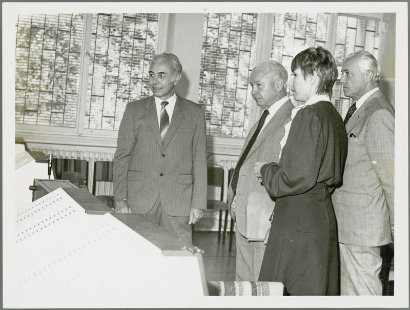 A woman translator, J. Toth and another man show Earl O. Heady research equipment in Hungary, 1979. The equipment could be computer monitors. Dr. Joseph Toth is Rector (President) of the Debrecen Agricultural University of Hungary.