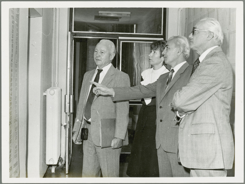 Earl O. Heady views a large chart of numbers on a wall in Hungary, with J. Toth, a man, and the woman translator. Dr. Joseph Toth is Rector (President) of the Debrecen Agricultural University of Hungary.