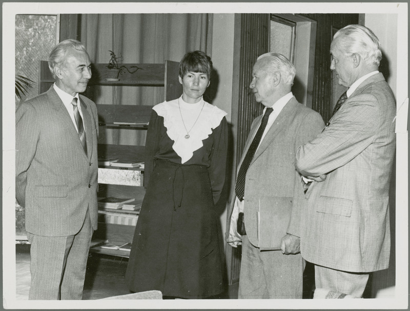 Earl O Heady talks with Dr. Joseph Toth, Rector (President) Debrecen Agricultural University of Hungary, a woman translator, and another man. Dr. Toth is the tall man on the right. Dr. Heady is in Hungary in 1979 to receive an honorary degree and present a lecture.