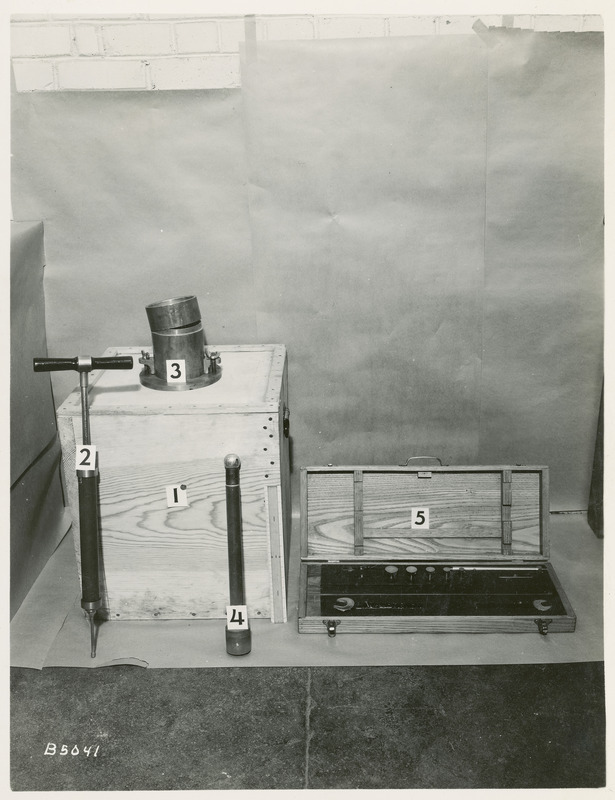 Five pieces of equipment, including a wooden box, are identified with numbers in preparation for soil testing, May 20, 1940.